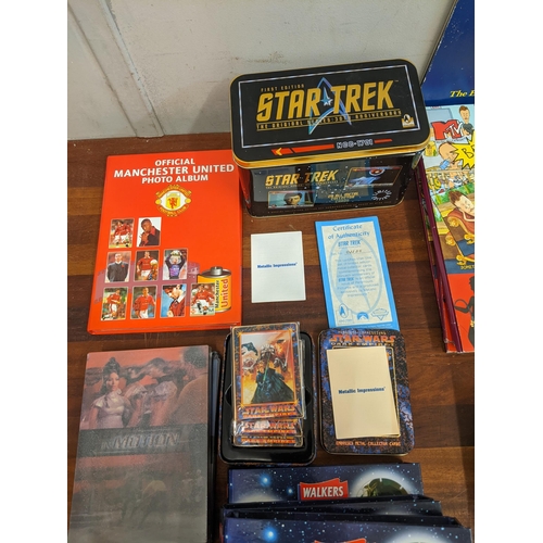 77 - A mixed lot of collectable items to include a tin of Star Trek first edition metal collectors cards,... 