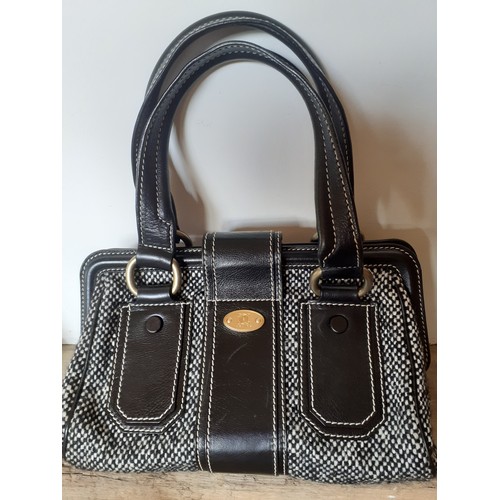 9 - Celine- A black and white woollen tweed 'Ella Frame' handbag and matching shoes, the bag having blac... 