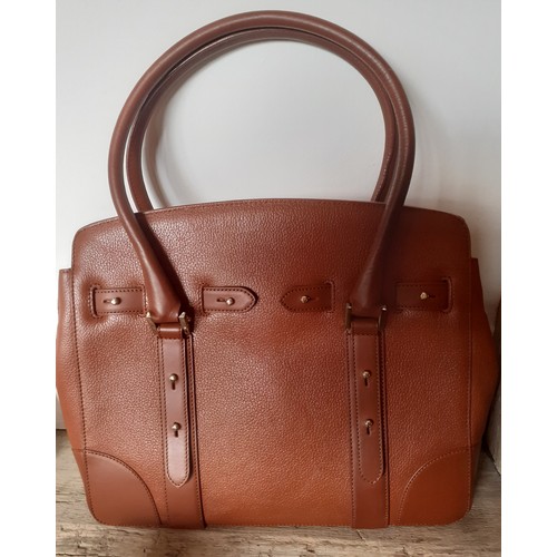 20 - Aspinal of London-A mid brown leather handbag having gold tone hardware with lock fastening and key,... 