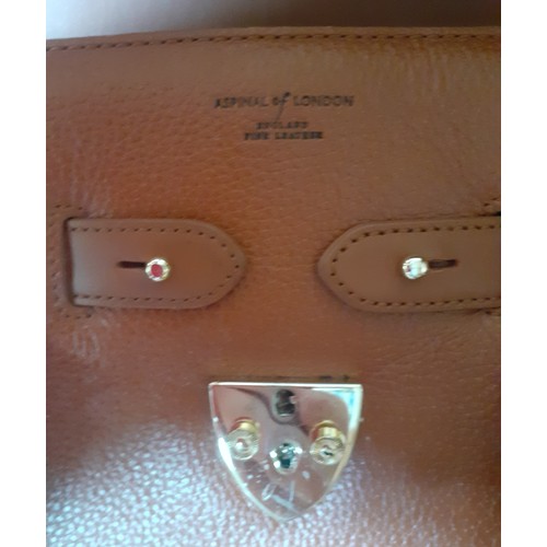 20 - Aspinal of London-A mid brown leather handbag having gold tone hardware with lock fastening and key,... 