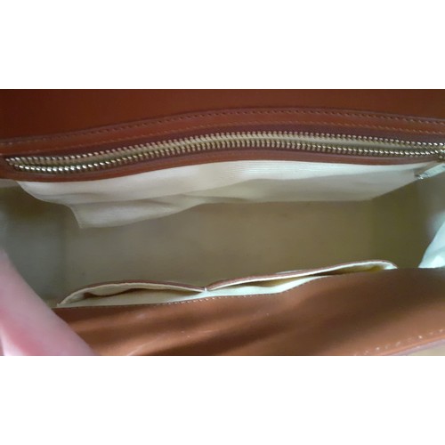 20 - Aspinal of London-A mid brown leather handbag having gold tone hardware with lock fastening and key,... 