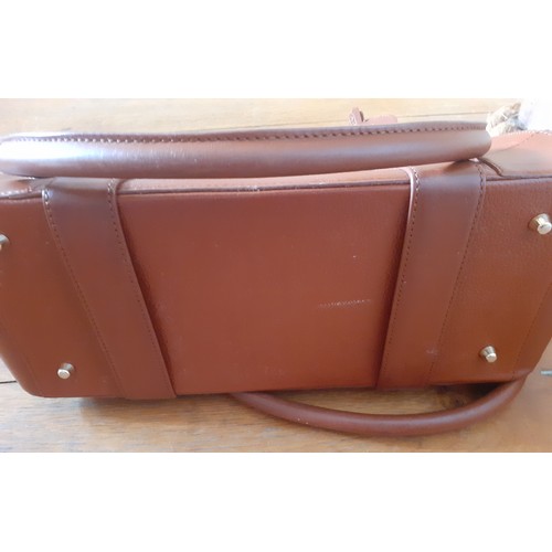 20 - Aspinal of London-A mid brown leather handbag having gold tone hardware with lock fastening and key,... 