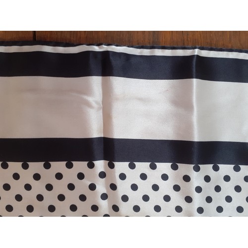 32 - Aspinal of London-A silk scarf having a design of black polka dots on a white ground with black stri... 