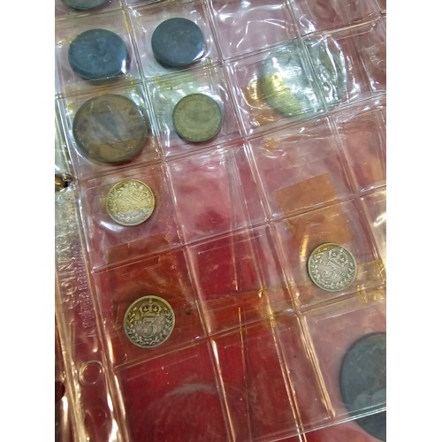 132 - An album containing Victorian and later coins to include 1887 Shilling, Victorian Threepence, halfpe... 