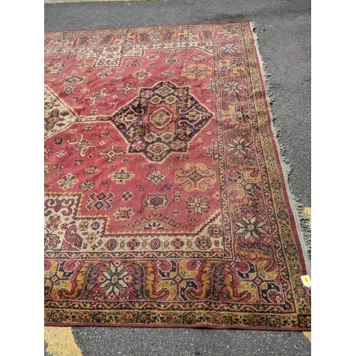 448 - A mid 20th century hand woven Persian style rug, possibly Turkish, three stylized floral central des... 