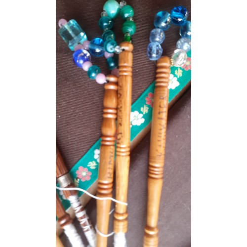 74 - A collection of lace bobbins and lace to include a wooden boxed wheel of turned wooden lace bobbins,... 