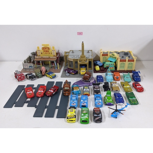 126 - A Disney Cars set with a set imitating Radiator Springs with various characters to include Lightning... 