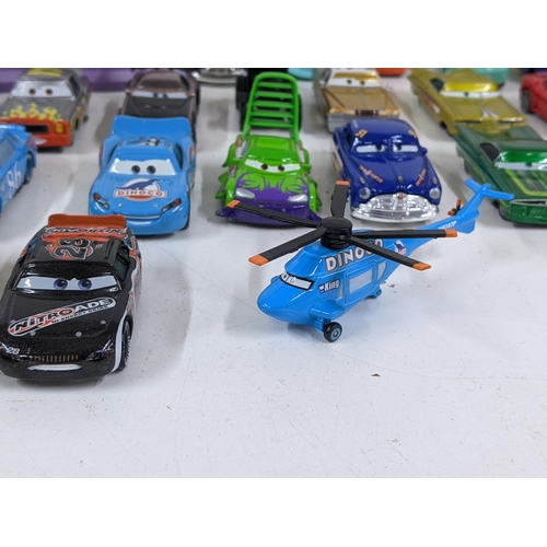 126 - A Disney Cars set with a set imitating Radiator Springs with various characters to include Lightning... 