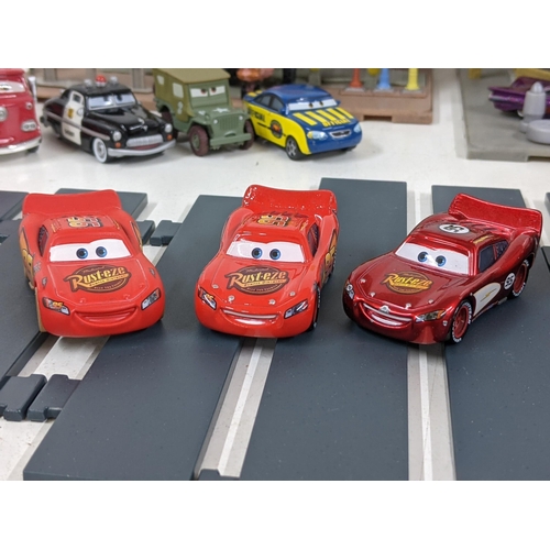 126 - A Disney Cars set with a set imitating Radiator Springs with various characters to include Lightning... 