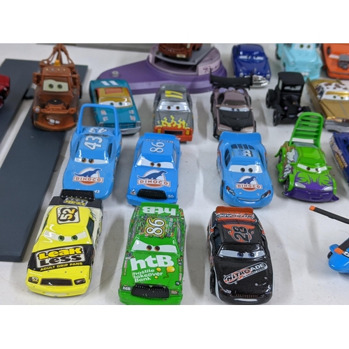 126 - A Disney Cars set with a set imitating Radiator Springs with various characters to include Lightning... 