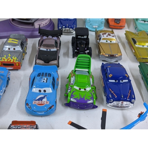 126 - A Disney Cars set with a set imitating Radiator Springs with various characters to include Lightning... 