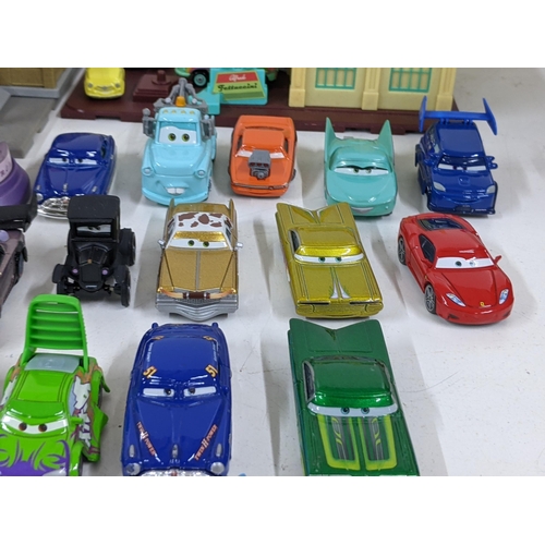 126 - A Disney Cars set with a set imitating Radiator Springs with various characters to include Lightning... 