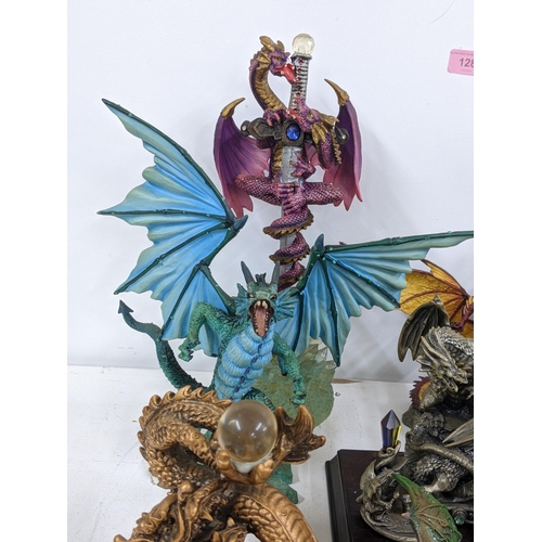 128 - Models of Dragons and fantasy creatures to include a purple limited edition Trigador worked around a... 