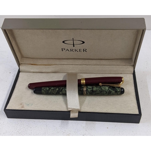 28 - A Parker Sonnet dark red coloured fountain pen and another Parker fountain pen with green marble eff... 