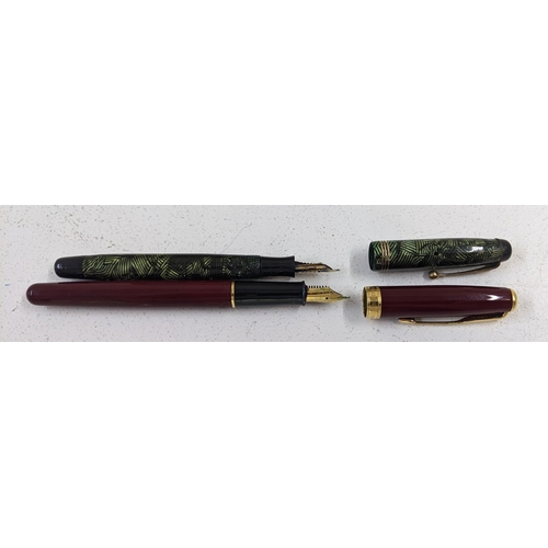 28 - A Parker Sonnet dark red coloured fountain pen and another Parker fountain pen with green marble eff... 