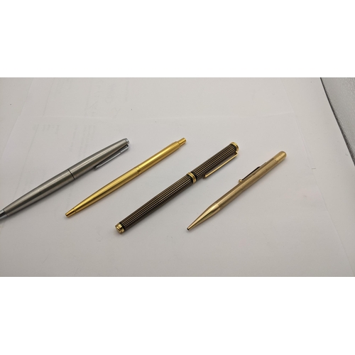 29 - Four pens to include a Parker biro, a gold coloured propelling pencil, a parker Fountain pen and gol... 