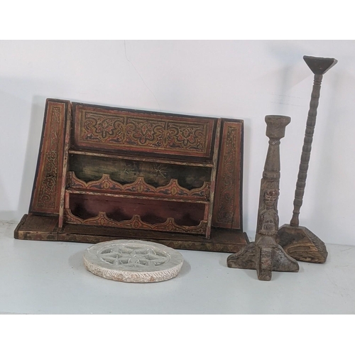 409 - A late 19th century hand painted wall hanging spice rack together with two carved Indian candlestick... 