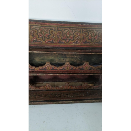 409 - A late 19th century hand painted wall hanging spice rack together with two carved Indian candlestick... 