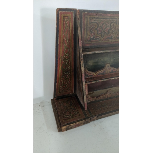 409 - A late 19th century hand painted wall hanging spice rack together with two carved Indian candlestick... 