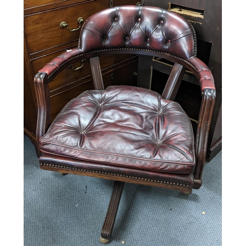 457 - A reproduction mahogany and red leather Chesterfield Captain's swivel armchair Location: BWR
If ther... 