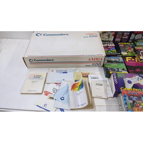 93 - A Commodore Amiga 500 in original box, packaging and original paperwork along with a large selection... 