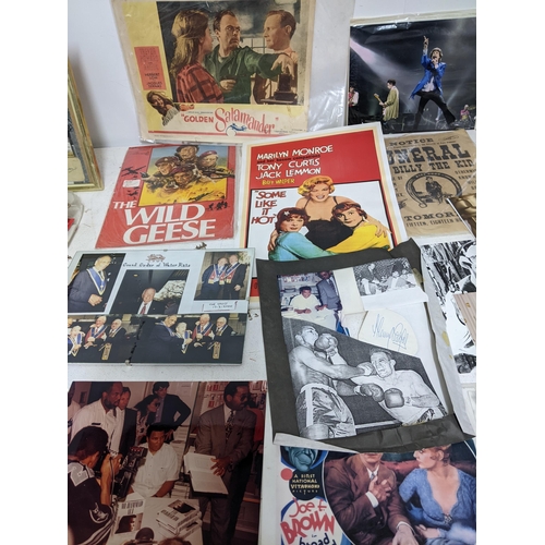 446 - A mixed lot of film, theatre and sporting memorabilia to include press photographs, lobby cards, the... 