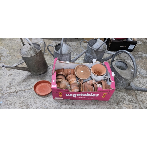 453 - A box of terracotta plant pots, various sizes and four assorted garden watering cans
Location: G
If ... 