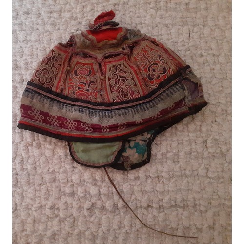 31 - An early 20th Century Chinese finely embroidered child's skull cap worked in panels vertically and h... 