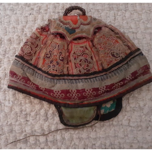 31 - An early 20th Century Chinese finely embroidered child's skull cap worked in panels vertically and h... 