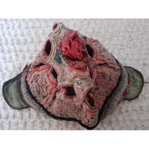 31 - An early 20th Century Chinese finely embroidered child's skull cap worked in panels vertically and h... 