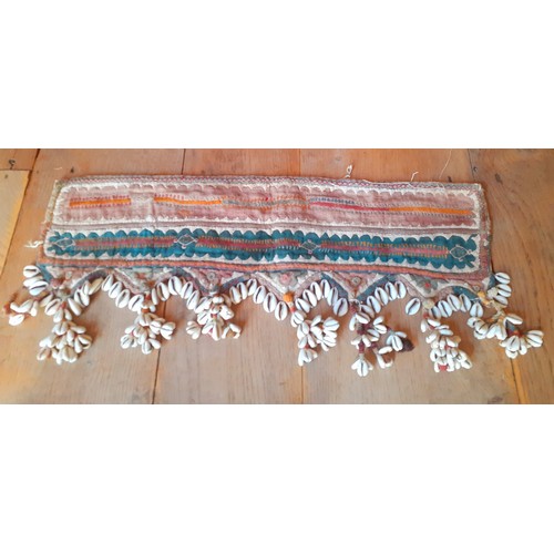 101 - A quantity of Banjara and other textiles to include purses and items decorated with cowrie beads and... 