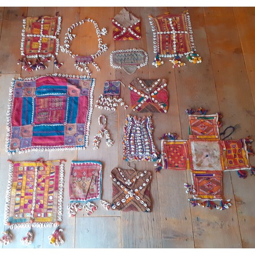 82 - A group of vintage Indian Banjara handmade and other textiles to include panels, 3 Banjara purses an... 