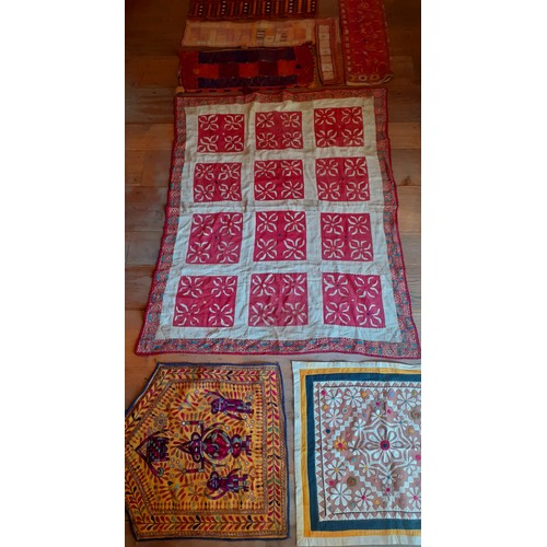 116 - A quantity of mainly mid 20th Century Indian hand embroidered textiles and clothing segments to incl... 