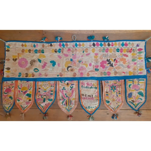 121 - Four vintage Indian hand-embroidered wall hangings and door Torans in various sizes and designs, the... 