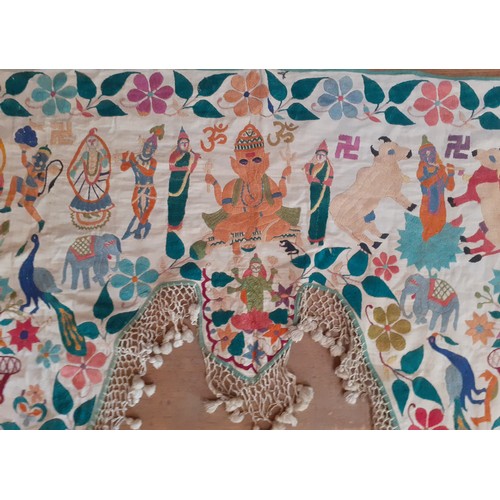 121 - Four vintage Indian hand-embroidered wall hangings and door Torans in various sizes and designs, the... 