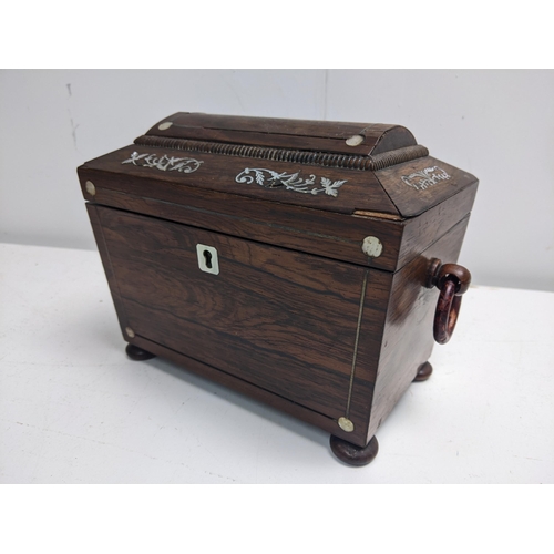 107 - A 19th century mother of pearl inlaid rosewood tea caddy of sarcophagus form, with ring handles and ... 