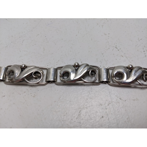 188 - A John Lauritzen Danish silver bracelet, with scrolled floral links, 19.5cm long

Location: CAB 5
If... 