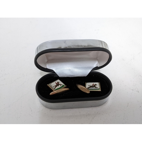 32 - A pair of vintage plated cufflinks, each panel decorated with a person on horseback. Location: CAB 5... 