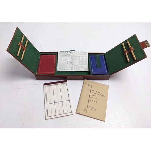 63 - A mid 20th century Bridge game set, with two packs of cards, four pencils, cards and rule book, in a... 