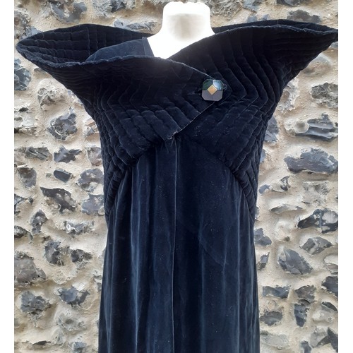 77 - A black velvet full length opera cape having a Gothic style raised collar with a hook and eye and si... 