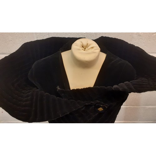 77 - A black velvet full length opera cape having a Gothic style raised collar with a hook and eye and si... 