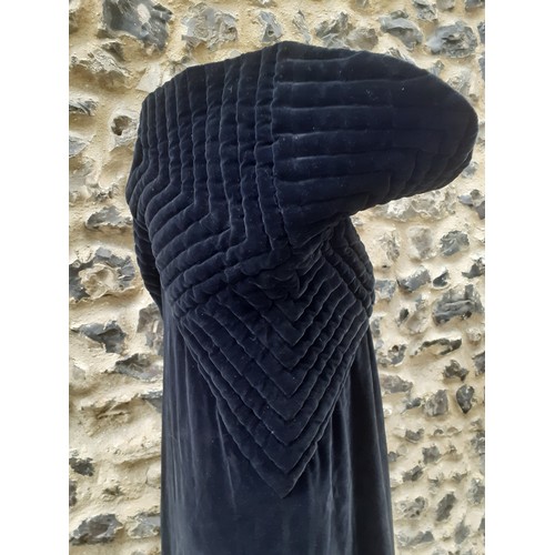 77 - A black velvet full length opera cape having a Gothic style raised collar with a hook and eye and si... 