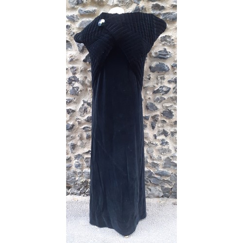 77 - A black velvet full length opera cape having a Gothic style raised collar with a hook and eye and si... 