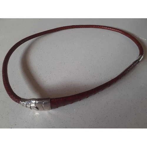 126 - A vintage red dyed braided leather belt having a snakeskin design with silver clasp and  collar stam... 