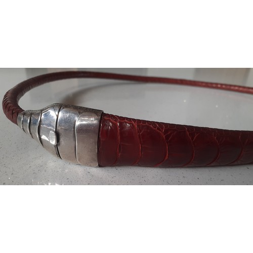 126 - A vintage red dyed braided leather belt having a snakeskin design with silver clasp and  collar stam... 