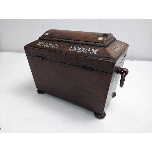 107 - A 19th century mother of pearl inlaid rosewood tea caddy of sarcophagus form, with ring handles and ... 