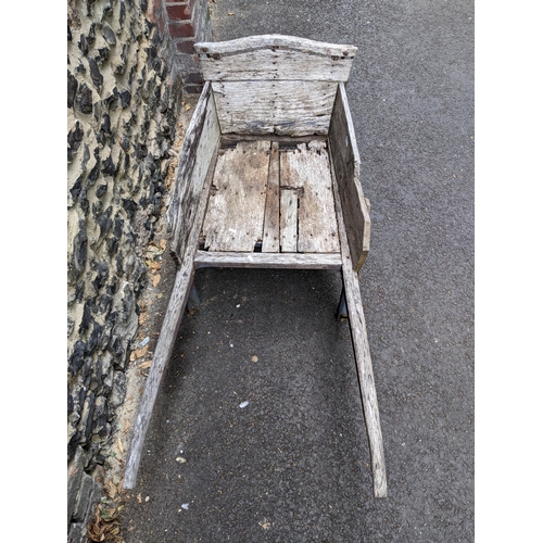 123 - An early 20th century wooden wheelbarrow with a wooden spoked wheel 
Location:G

Location:
If there ... 