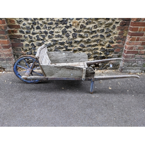 123 - An early 20th century wooden wheelbarrow with a wooden spoked wheel 
Location:G

Location:
If there ... 