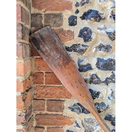 214 - A vintage wooden oar with a shaped blade and turned handle, 131cm long. Location: RWM

Location:
If ... 