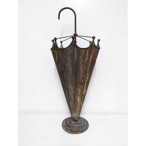 229 - A gilt metal stick stand fashioned as an umbrella, with a curved handle and lobed body, on a stepped... 